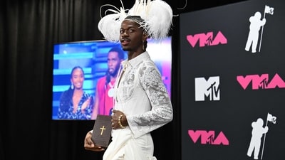 US rapper Lil Nas X poses in the press room during the MTV Video Music Awards at the Prudential Center. He wore a white lace-work mini dress styled with a corset and a statement-making headdress. (AFP) US rapper Lil Nas X poses in the press room during the MTV Video Music Awards at the Prudential Center. He wore a white lace-work mini dress styled with a corset and a statement-making headdress. (AFP)