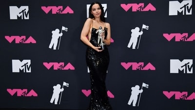 US singer Dove Cameron poses with her Video for Good award in the press room during the MTV Video Music Awards at the Prudential Center. She chose a risqué black sequinned backless gown for the occasion. It features noodle straps and a form-fitting silhouette. (AFP) US singer Dove Cameron poses with her Video for Good award in the press room during the MTV Video Music Awards at the Prudential Center. She chose a risqué black sequinned backless gown for the occasion. It features noodle straps and a form-fitting silhouette. (AFP)