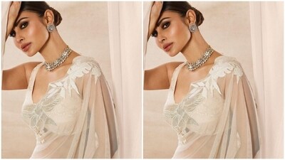 Mouni looked dreamy in the white translucent chiffon saree featuring white floral zari details at the borders. (Instagram/@imouniroy) Mouni looked dreamy in the white translucent chiffon saree featuring white floral zari details at the borders. (Instagram/@imouniroy)