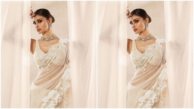 Styled by fashion stylist Maneka Hari Singhani, Mouni wore her tresses into a sleek bun with a middle part as she posed against a white backdrop. (Instagram/@imouniroy) Styled by fashion stylist Maneka Hari Singhani, Mouni wore her tresses into a sleek bun with a middle part as she posed against a white backdrop. (Instagram/@imouniroy)