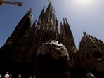 A big cardboard ice cream sits at a terrace of a bar, as tourists walk in front of Sagrada Familia basilica in Barcelona, Spain.