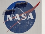 FILE - Workers on scaffolding repaint the NASA logo near the top of the Vehicle Assembly Building at the Kennedy Space Center in Cape Canaveral, Fla., Wednesday, May 20, 2020. After a yearlong study into UFOs, NASA is releasing a report Thursday, Sept. 14, 2023, on what it needs to better understand unidentified flying objects from a scientific point of view.