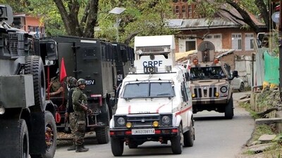 Army personnel and a CRPF vehicle near the site where the encounter is underway between security forces and militants in the Garol forest near Kokernag in Anantnag district on Thursday. (ANI Photo) Army personnel and a CRPF vehicle near the site where the encounter is underway between security forces and militants in the Garol forest near Kokernag in Anantnag district on Thursday. (ANI Photo)