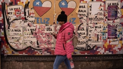 A pedestrian in front of a wall covered with posters of approval and rejection of the New Constitution in Santiago, Chile, on Thursday, July 27, 2023. Photographer: Tamara Merino/Bloomberg (Bloomberg) A pedestrian in front of a wall covered with posters of approval and rejection of the New Constitution in Santiago, Chile, on Thursday, July 27, 2023. Photographer: Tamara Merino/Bloomberg (Bloomberg)