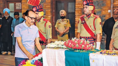 J&K DSP Humayun Muzamil Bhat’s father and retired IGP, Ghulam Hassan Bhat, lays a wreath on his son’s coffin in Srinagar on Wednesday. (PTI) J&K DSP Humayun Muzamil Bhat’s father and retired IGP, Ghulam Hassan Bhat, lays a wreath on his son’s coffin in Srinagar on Wednesday. (PTI)