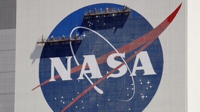 FILE - Workers on scaffolding repaint the NASA logo near the top of the Vehicle Assembly Building at the Kennedy Space Center in Cape Canaveral, Fla., Wednesday, May 20, 2020. After a yearlong study into UFOs, NASA is releasing a report Thursday, Sept. 14, 2023, on what it needs to better understand unidentified flying objects from a scientific point of view. (AP) FILE - Workers on scaffolding repaint the NASA logo near the top of the Vehicle Assembly Building at the Kennedy Space Center in Cape Canaveral, Fla., Wednesday, May 20, 2020. After a yearlong study into UFOs, NASA is releasing a report Thursday, Sept. 14, 2023, on what it needs to better understand unidentified flying objects from a scientific point of view. (AP)