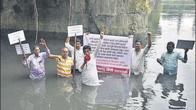 On Thursday afternoon, Sangam Dongre, a social worker, along with a few others stood in the creek waters to draw the attention of authorities. (Praful Gangurde / HT Photo) On Thursday afternoon, Sangam Dongre, a social worker, along with a few others stood in the creek waters to draw the attention of authorities. (Praful Gangurde / HT Photo)