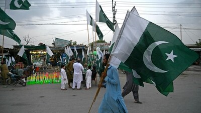 Pakistan Elections: A man carrying Pakistan's national flags, walks through a street on the eve of country's Independence Day celebrations in Peshawar. (AFP) Pakistan Elections: A man carrying Pakistan's national flags, walks through a street on the eve of country's Independence Day celebrations in Peshawar. (AFP)