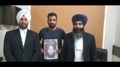 Rampreet Singh , son of Harjeet Singh who was killed in a fake encounter ( in the middle and showing the file photo of his father) standing along with his legal counsels after the quantum of sentence. (HT photo)