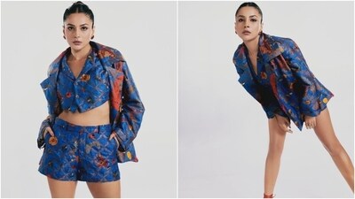 Shehnaaz wore a deep blue-coloured cropped waistcoat, jacket and shorts set decorated in floral patterns of red, mustard, yellow, green and bronze shades. While the waistcoat has notch lapel collars and front button closures, the jacket has wide collars, an open front, full-length sleeves, and a relaxed fitting. She styled the ensemble with killer high heels, a centre-parted sleek top knot, statement earrings, and striking glam picks.&nbsp; (Instagram)