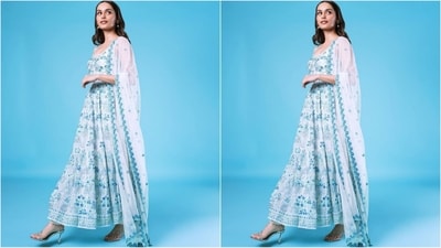 Her anarkali kurta features organza fabric, thin stripes, a round neckline and light blue thread and sequin embroidery all over. She paired it with white pyjamas and a net dupatta with blue embroidered borders. (Instagram/@manushi_chhillar) Her anarkali kurta features organza fabric, thin stripes, a round neckline and light blue thread and sequin embroidery all over. She paired it with white pyjamas and a net dupatta with blue embroidered borders. (Instagram/@manushi_chhillar)