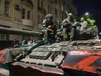 Members of the Wagner Group military company sit atop of a tank on a street in Rostov-on-Don, Russia.