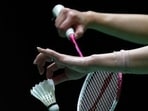 A detail shot of a shuttlecock and racquet 