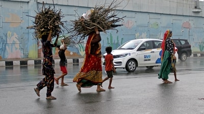 Pedestrians cross the road on Delhi-Gurugram Expressway amid heavy rainfall. (ANI / File)
