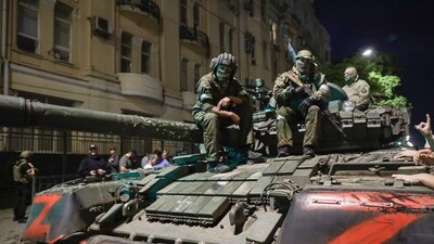 Members of the Wagner Group military company sit atop of a tank on a street in Rostov-on-Don, Russia. (AP)