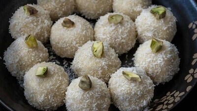 Coconut laddoo: Coconut laddoo is made with grated coconut, condensed milk, cardamom powder, and ghee, and shaped into balls, before being garnished by chopped nuts. (Pinterest) Coconut laddoo: Coconut laddoo is made with grated coconut, condensed milk, cardamom powder, and ghee, and shaped into balls, before being garnished by chopped nuts. (Pinterest)