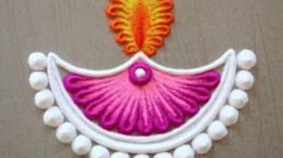 Diya Design: For a diya design, start by creating a large diya (oil lamp) in the center of your rangoli, add flames to the diya using small, interconnected semi-circles, then surround the diya with flower petals and leaves, and use red, orange, and yellow colors for the diya and green for the leaves. (Pinterest) Diya Design: For a diya design, start by creating a large diya (oil lamp) in the center of your rangoli, add flames to the diya using small, interconnected semi-circles, then surround the diya with flower petals and leaves, and use red, orange, and yellow colors for the diya and green for the leaves. (Pinterest)