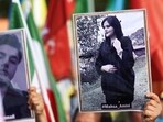 A person holds a picture of Mahsa Amini in a rally on the eve of the first anniversary of her death, 