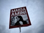 Iran Anti-Hijab Protests: A woman holds a placard with a picture of Iranian woman Mahsa Amini during a protest against her death. Iran Anti-Hijab Protests: A woman holds a placard with a picture of Iranian woman Mahsa Amini during a protest against her death.