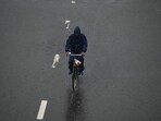 Commuter braving the rain in Noida on Saturday. Commuter braving the rain in Noida on Saturday.