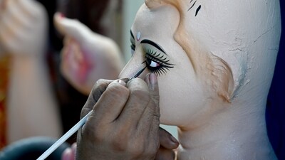 An artist adding the finishing touches to the idol of the Hindu god Vishwakarma for the upcoming Vishwakarma Puja at Sector 31, in Noida. People install frames and idols of Lord Vishwakarma at the intersections of crossroads and place statues and idols of him on street corners during this occasion. (HT Photo/Sunil Ghosh) An artist adding the finishing touches to the idol of the Hindu god Vishwakarma for the upcoming Vishwakarma Puja at Sector 31, in Noida. People install frames and idols of Lord Vishwakarma at the intersections of crossroads and place statues and idols of him on street corners during this occasion. (HT Photo/Sunil Ghosh)
