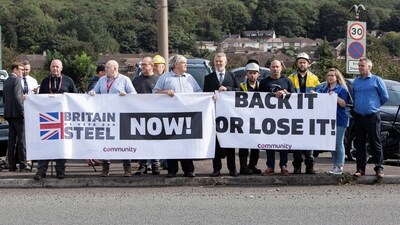 Protesters hold signs outside Tata Steel, on the day of a government announcement about steel industry investments, in Port Talbot, Britain September 15, 2023. REUTERS/Joann Randles (Reuters)