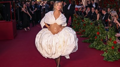 Sienna Miller showed off her baby bump as she walked the red carpet in a Schiaparelli creation. She served a modern approach to pregnancy fashion with her gorgeous look. She wore a skirt and cropped shirt styled with statement earrings, minimal glam, a messy hairdo, sheer black stockings, and high heels. (Vianney Le Caer/Invision/AP) Sienna Miller showed off her baby bump as she walked the red carpet in a Schiaparelli creation. She served a modern approach to pregnancy fashion with her gorgeous look. She wore a skirt and cropped shirt styled with statement earrings, minimal glam, a messy hairdo, sheer black stockings, and high heels. (Vianney Le Caer/Invision/AP)