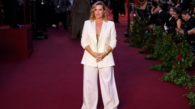 Kate Winslet made a red carpet appearance at the Vogue World event in a white, loose-fitting suit over a nude-coloured bustier - a nod to the visible lingerie trend. She styled the ensemble with a shoulder-length bob, a touch of bronzer on the cheekbones, smoky gold eyeshadow and rosewood lipstick.&nbsp; (REUTERS)
