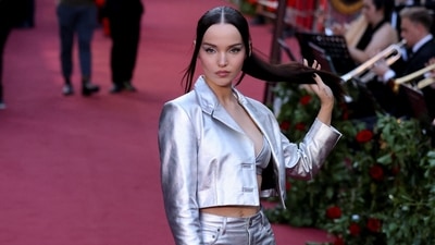 Dove Cameron attends Vogue World even in head-to-toe Coach. She wore a silver bralette, a crop jacket, and flared pants.&nbsp; (REUTERS)