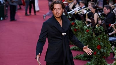 Actor Cole Sprouse poses for the paparazzi in a black suit during the Vogue World event in London.&nbsp; (REUTERS)
