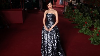 Gemma Chan embraced romantic dressing in a custom Louis Vuitton strapless gown featuring a drop waist, a full skirt that juts out from the hip, and a floor-length hem. She styled the ensemble with diamond and blue sapphire jewels, a low bun, smoky eyes, and a bold red lip.&nbsp; (REUTERS)