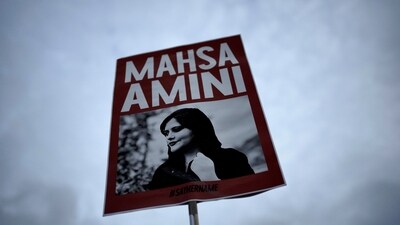 Iran Anti-Hijab Protests: A woman holds a placard with a picture of Iranian woman Mahsa Amini during a protest against her death. (AP) Iran Anti-Hijab Protests: A woman holds a placard with a picture of Iranian woman Mahsa Amini during a protest against her death. (AP)