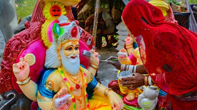 An artisan gives final touches to an idol of Hindu god Vishwakarma ahead of the Vishwakarma Jayanti in Amritsar. Vishwakarma Puja is seen as an occasion for labourers and artisans to enhance productivity and seek divine inspiration for innovating new products, usually observed within the confines of factories, shops, offices, or workshops. (PTI) An artisan gives final touches to an idol of Hindu god Vishwakarma ahead of the Vishwakarma Jayanti in Amritsar. Vishwakarma Puja is seen as an occasion for labourers and artisans to enhance productivity and seek divine inspiration for innovating new products, usually observed within the confines of factories, shops, offices, or workshops. (PTI)