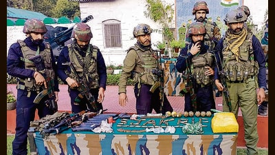 Security personnel with arms and ammunition recovered from militants in Hatlanga area of Uri in Baramulla. (PTI) Security personnel with arms and ammunition recovered from militants in Hatlanga area of Uri in Baramulla. (PTI)