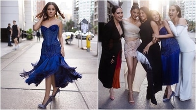 Shehnaaz Gill chose a midnight blue strapless midi dress for the photoshoot. It features a corseted bodice, intricate embellishments on the torso, tassels attached to the hem forming a skirt, and a figure-hugging silhouette. She styled the ensemble with high-heel pumps, dainty ear studs, smoky eyes, on-fleek brows, shimmering highlighter, glossy mauve lip shade, and centre-parted open wavy locks. (Instagram) Shehnaaz Gill chose a midnight blue strapless midi dress for the photoshoot. It features a corseted bodice, intricate embellishments on the torso, tassels attached to the hem forming a skirt, and a figure-hugging silhouette. She styled the ensemble with high-heel pumps, dainty ear studs, smoky eyes, on-fleek brows, shimmering highlighter, glossy mauve lip shade, and centre-parted open wavy locks. (Instagram)