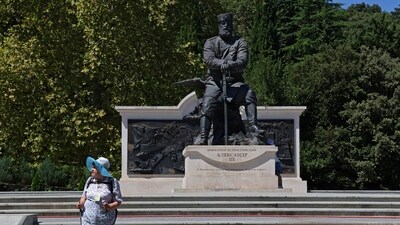 A woman walks near the statue of Russian Emperor Alexander III at the Livadia Palace in Yalta, Crimea. (REUTERS)