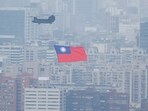 China-Taiwan Conflict: A Chinook helicopter carrying a Taiwan flag flies over the city during the country's National Day celebration in Taipei, Taiwan.