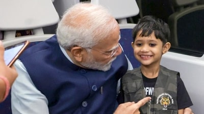 PM Modi interacts with a child while travelling in the metro. (ANI) PM Modi interacts with a child while travelling in the metro. (ANI)