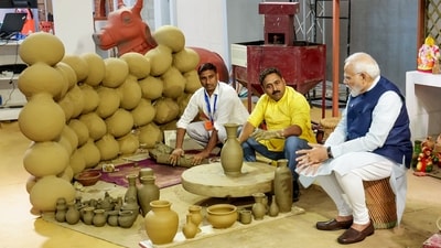 Prime Minister Narendra Modi meets potters during an exhibition at the inauguration of the first phase of India International Convention and Expo Centre (IICC), named Yashobhoomi, at Dwarka, in New Delhi on Sunday. (PMO) Prime Minister Narendra Modi meets potters during an exhibition at the inauguration of the first phase of India International Convention and Expo Centre (IICC), named Yashobhoomi, at Dwarka, in New Delhi on Sunday. (PMO)
