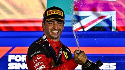 Ferrari's Spanish driver Carlos Sainz Jr sprays champagne as he celebrates on the podium after winning the Singapore Formula One Grand Prix night race at the Marina Bay Street Circuit (AFP) Ferrari's Spanish driver Carlos Sainz Jr sprays champagne as he celebrates on the podium after winning the Singapore Formula One Grand Prix night race at the Marina Bay Street Circuit (AFP)