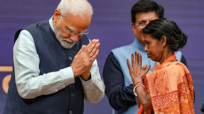 PM Modi with a 'Vishwakarma' during the launch of 'PM Vishwakarma' scheme at India International Convention and Expo Centre (IICC) (PTI) PM Modi with a 'Vishwakarma' during the launch of 'PM Vishwakarma' scheme at India International Convention and Expo Centre (IICC) (PTI)