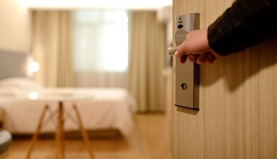 A person opening a hotel room A person opening a hotel room
