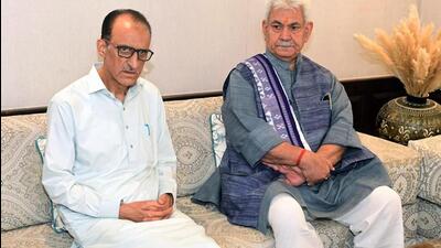 Jammu and Kashmir lieutenant governor Manoj Sinha with Ghulam Hassan Bhat, the father of Jammu and Kashmir DSP Humayun Bhat, in Budgam on Monday. (ANI Photo) Jammu and Kashmir lieutenant governor Manoj Sinha with Ghulam Hassan Bhat, the father of Jammu and Kashmir DSP Humayun Bhat, in Budgam on Monday. (ANI Photo)