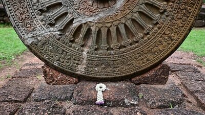 A prayer garland next to the 6th-9th Century B.C Dharmachakra artifact at the Si Thep historical site in Thailand's Phetchabun province. (AFP) A prayer garland next to the 6th-9th Century B.C Dharmachakra artifact at the Si Thep historical site in Thailand's Phetchabun province. (AFP)
