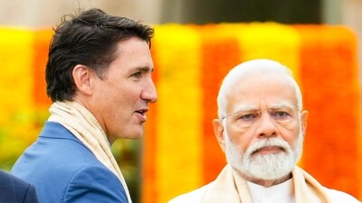 Canada's Prime Minister Justin Trudeau walks past India's Prime Minister Narendra Modi (AP)