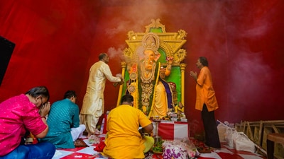 Priests and devotees offer prayers to Lord Ganesha at a community puja pandal on the occasion of Ganesh Chaturthi festival in Kolkata. (PTI) Priests and devotees offer prayers to Lord Ganesha at a community puja pandal on the occasion of Ganesh Chaturthi festival in Kolkata. (PTI)