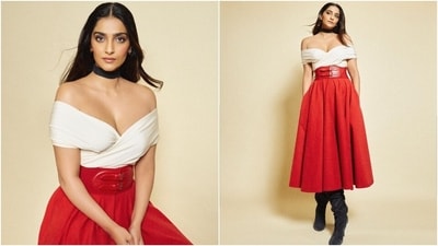 While the cropped blouse features a plunging neckline, fitted bust, an overlapping silhouette, and an off-the-shoulder design, the skirt features a high-rise waist, pleats to lend a structure, and a midi hem length. She styled it with a corset belt in a deep red shade and featuring a belt embellishment. While the cropped blouse features a plunging neckline, fitted bust, an overlapping silhouette, and an off-the-shoulder design, the skirt features a high-rise waist, pleats to lend a structure, and a midi hem length. She styled it with a corset belt in a deep red shade and featuring a belt embellishment.