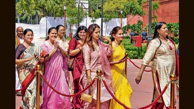 Women MPs walk to the new Parliament on Tuesday. (PTI) Women MPs walk to the new Parliament on Tuesday. (PTI)