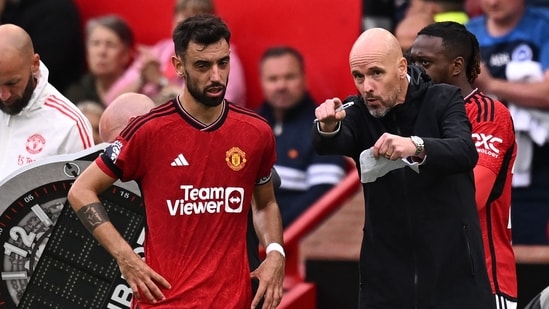 Manchester United's Dutch manager Erik ten Hag (R) gives instructions to Manchester United's Portuguese midfielder #08 Bruno Fernandes (L) (AFP)
