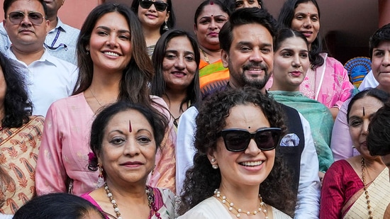 Kangana Ranaut and Esha Gupta pose for group photos with parliamentarians during the special session of Parliament, in New Delhi, Tuesday, Sept. 19, 2023. (PTI)